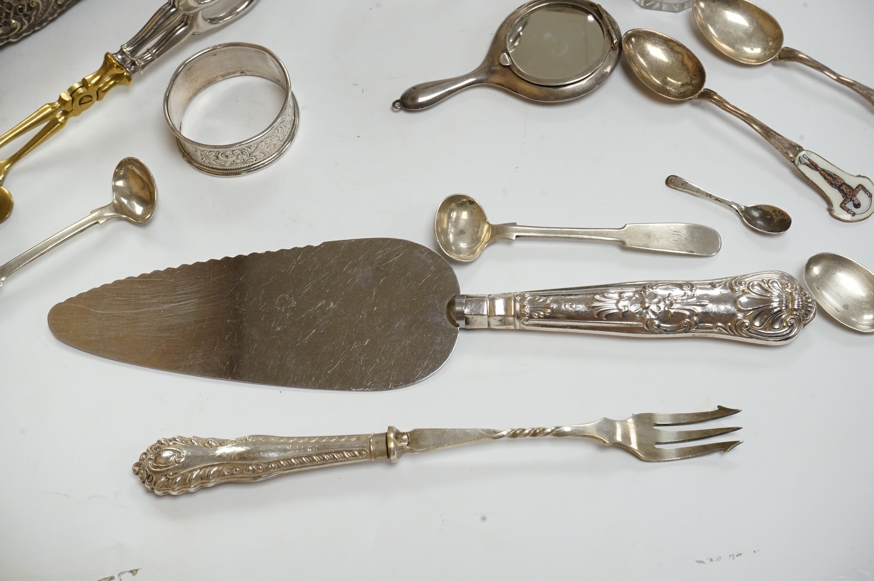 A late Victorian repousse silver mounted rectangular easel mirror, Birmingham, 1896, 35.7cm(a.f.), together with a modern silver mounted photograph frame, a silver handbag mirror/compact, three mounted glass toilet jars,